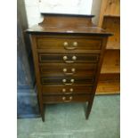 An Edwardian mahogany and satinwood banded music cabinet