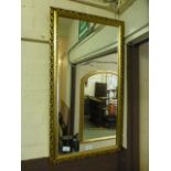 A gilt framed mirror