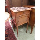 An Edwardian walnut pot cupboard with brown marble top