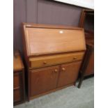 A mid-20th century teak fall front bureau