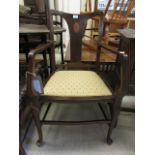 An early 20th century mahogany inlaid open arm chair