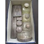 A box containing white metal topped scent bottles etc.