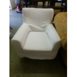 A modern white upholstered arm chair