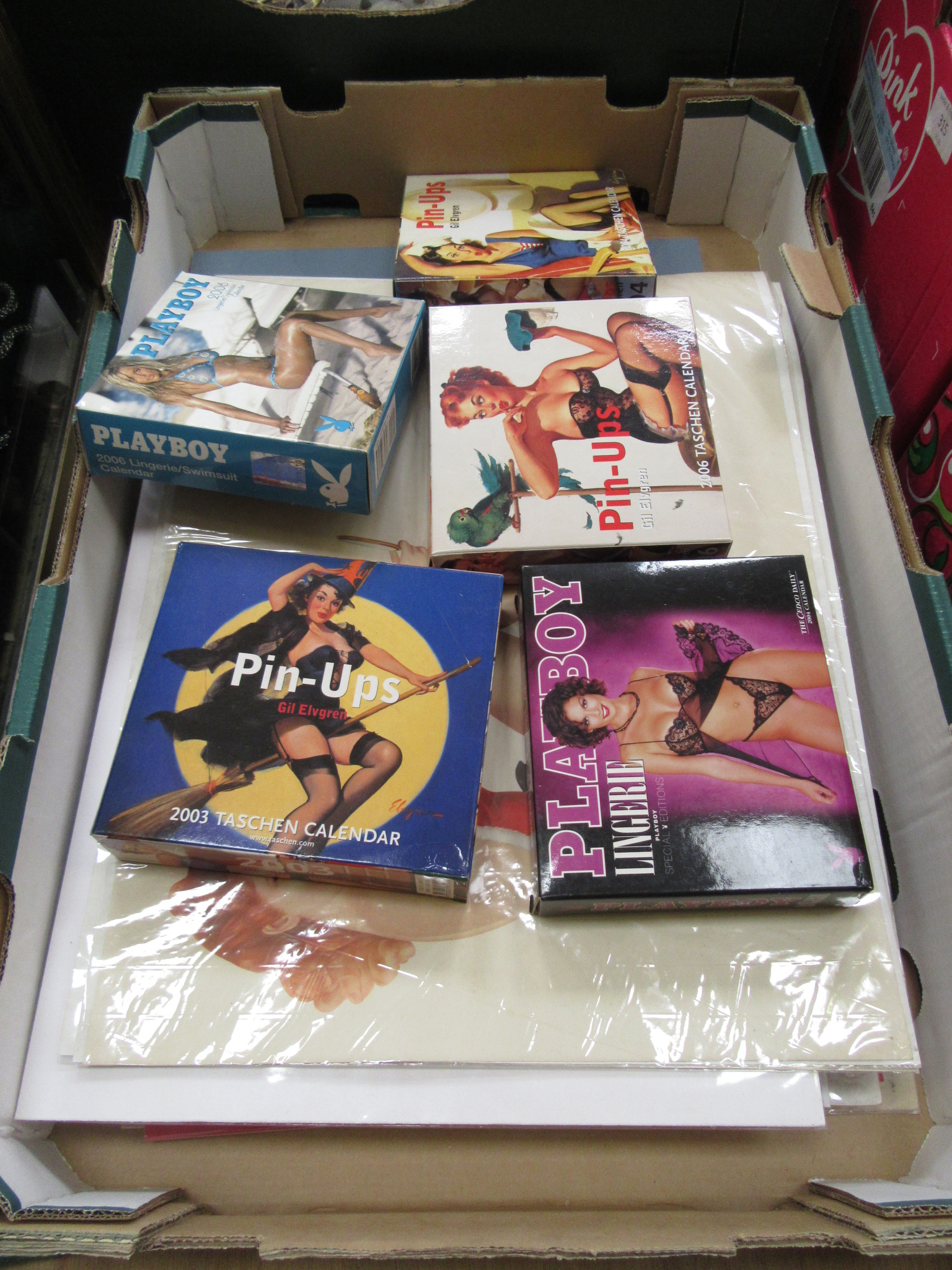 A tray containing Playboy boxed calendars, mounted calendars etc.