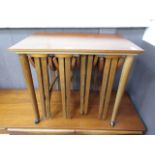 A mid-20th century teak table having four drop-leaf tables to under