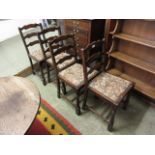 A set of four early 20th century oak dining chairs