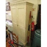 A cream painted two door wardrobe