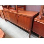 A mid-20th century teak sideboard having two doors and three drawers