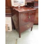 A mahogany commode having two drawers above pull-out seat