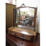 An early 19th century mahogany, boxwood strung and rosewood banded toilet mirror, the plate on