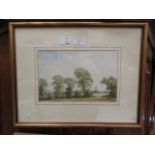 A framed and glazed watercolour of country scene with church in foreground signed John Killingback