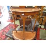 A mid-20th century walnut veneered demi-lune hall table