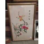 A framed and glazed oriental silk work