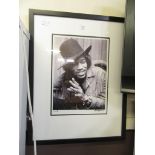 A framed and glazed photographic print of Jimi Hendrix