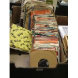 A tray containing a selection of 45rpm singles and 78s by various artists to include Sony and Cher,