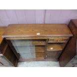 A mid-20th century oak cabinet having two sliding glazed doors with single drawer above open