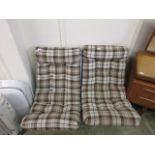 A pair of chrome relaxing chairs with brown wool upholstery