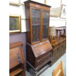 An early 20th century oak bureau book case