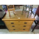 A satinwood chest of three long graduated drawers