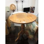 A waxed pine pedestal occasional table