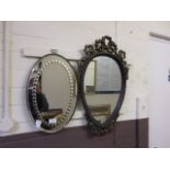 Two small oval wall mirrors