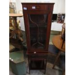 A reproduction mahogany effect display cabinet on a detachable base having two drawers above a long