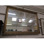 An ornate gilt framed rectangular wall mirror