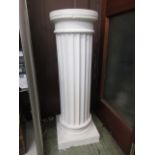 A white painted pedestal