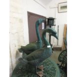 Two green painted aluminium geese