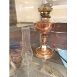A brass and copper oil lamp