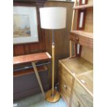 A hand crafted wooden and chrome standard lamp