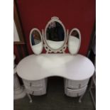 A cream painted kidney shaped dressing table with triple vanity mirror to back