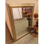 A gold framed rectangular mirror