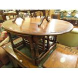 A reproduction oak oval occasional table having a two under