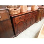 A modern high quality oak dresser base having three drawers over three field panel doors