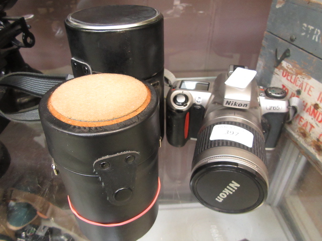 A Nikon camera together with two lenses