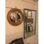 A gilt framed convex mirror along with one other