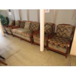 An early 20th century suite comprising of four armchairs and a three seat mahogany caned sofa