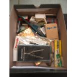 A box containing an assortment of writing instruments, rules, pencils etc.