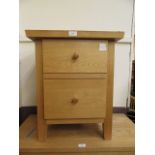 A modern two drawer bedside chest