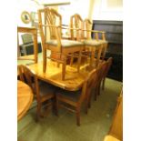 An extending pine dining table along with a set of eight (6+2 matching) dining chairs