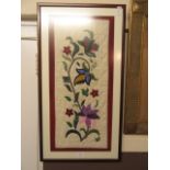 A framed and glazed material artwork of flowers