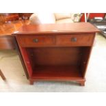 A reproduction mahogany open bookcase with two drawers