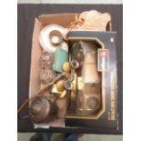 A box containing an assortment of items to include a pair of small slippers, binoculars,