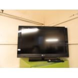 A Sony Bravia flat screen TV with remote