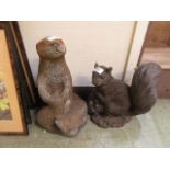 Two garden statues of otters and a squirrel