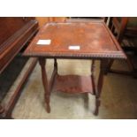 An early 20th century oak occasional table with under tier