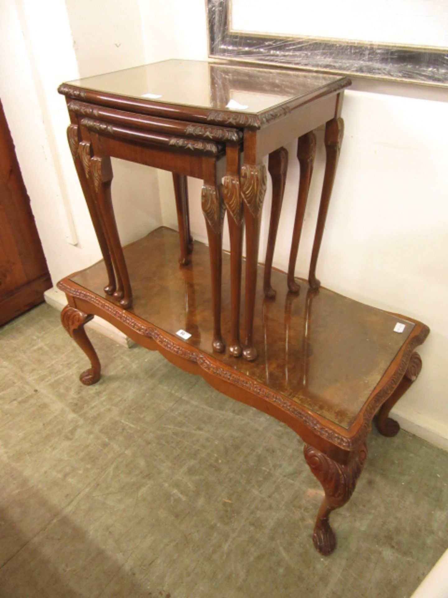 A nest of three burr walnut topped occasional tables along with a matching coffee table