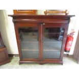 An early 20th century mahogany bookcase two glazed doors enclosing adjustable shelving