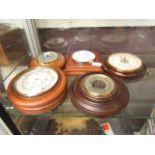 A collection of four barometers and one hygrometer